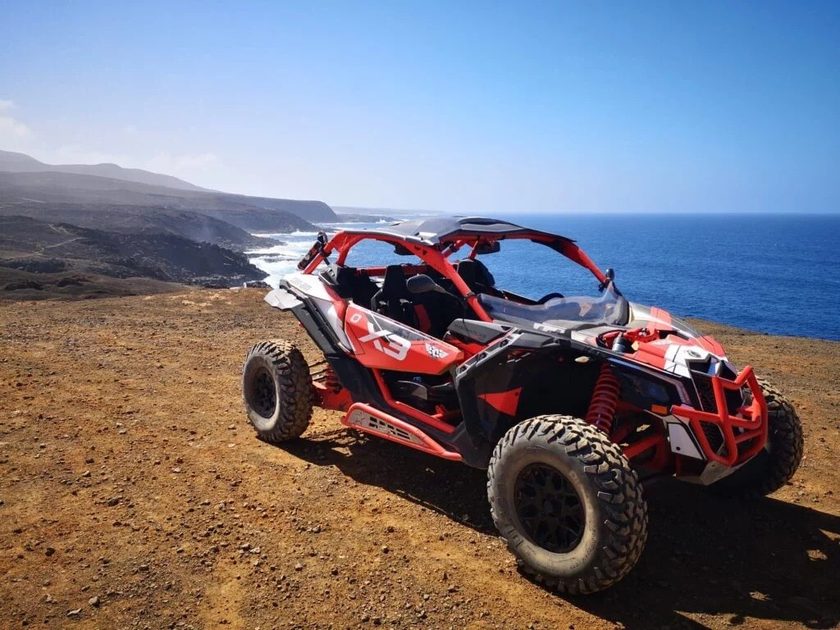 Buggy tour through volcanic landscape Lanzarote — off-road adventure driving through lava fields and dusty tracks with mountain views