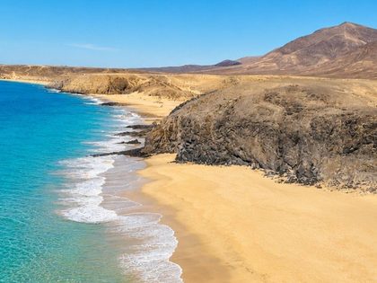 Cala de la Cera Lanzarote — small secret cove west of Papagayo, golden sand and crystal-clear turquoise water enclosed by volcanic cliffs in the Los Ajaches Natural Monument