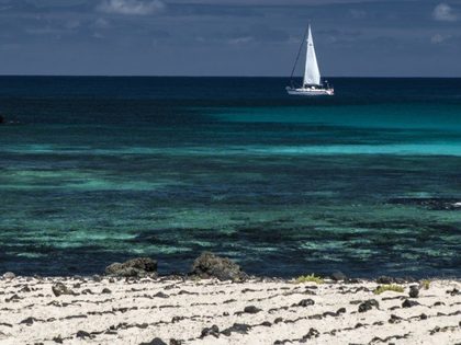 Caletón Blanco near Orzola Lanzarote — small coves of almost-white sand separated by strips of black lava, with crystal-clear turquoise water and natural rock pools forming at low tide