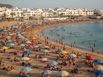 Crowded beach in Lanzarote during peak summer season