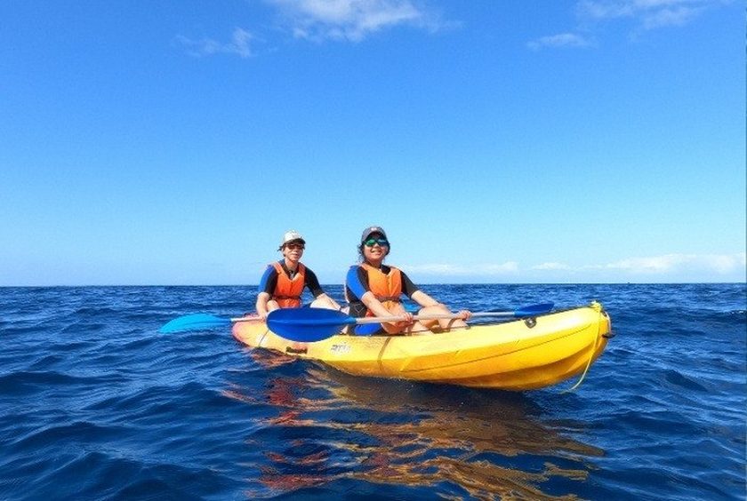 Kayaking along volcanic cliffs Papagayo beaches Lanzarote — clear turquoise water with dramatic rock formations and secluded coves