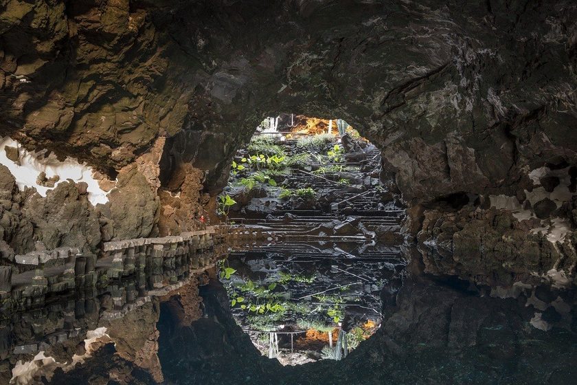 Jameos del Agua Lanzarote — Cesar Manrique underground volcanic cave with turquoise natural pool, palm trees and white architecture